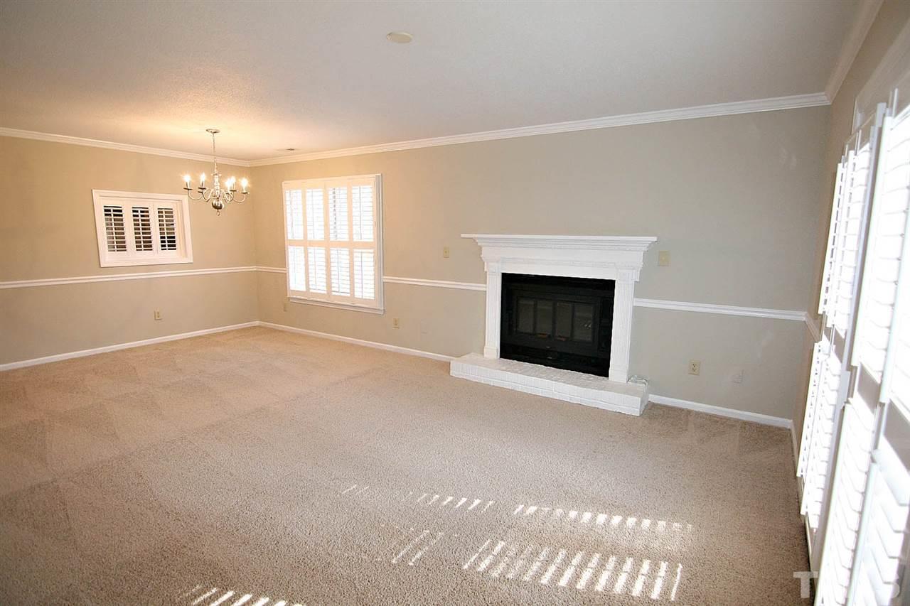 1581 Laureldale Drive Raleigh, NC 27609 - Photo 9 of 21 an empty room with windows and fireplace