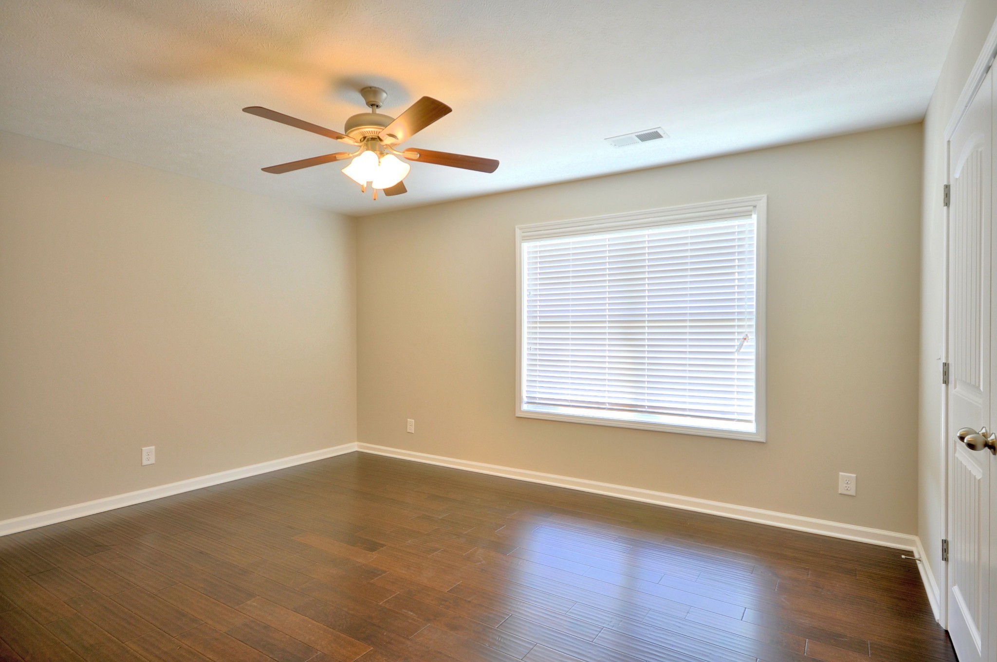 117 Melbourne Drive, Unit E Clarksville, TN 37043 - Photo 13 of 17 a view of an empty room with wooden floor and a window