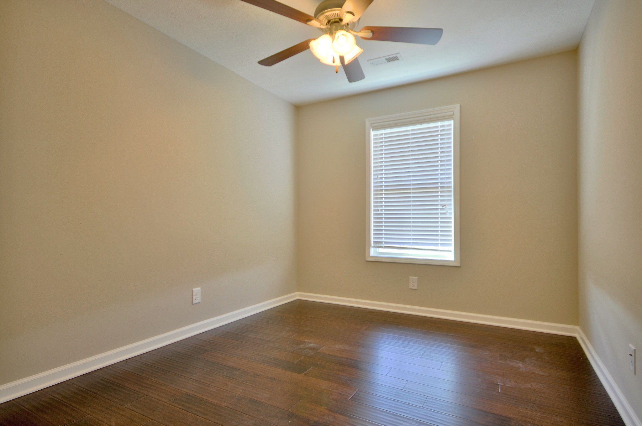 117 Melbourne Drive, Unit E Clarksville, TN 37043 - Photo 8 of 17 a view of an empty room with wooden floor and a window