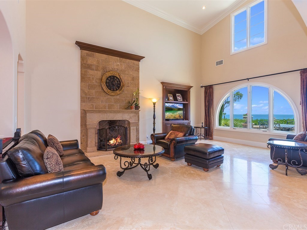 26 Tideline Bluff Newport Coast, CA 92657 - Photo 13 of 31 a living room with furniture and a fireplace