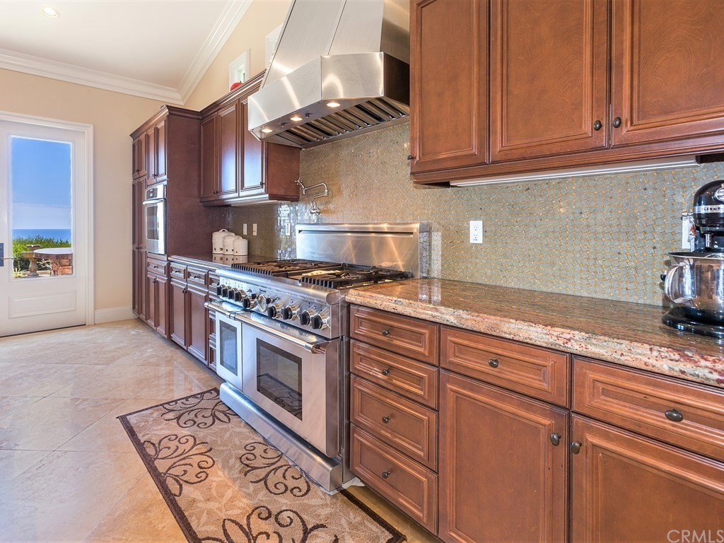 26 Tideline Bluff Newport Coast, CA 92657 - Photo 17 of 31 a kitchen with granite countertop a sink a stove and cabinets