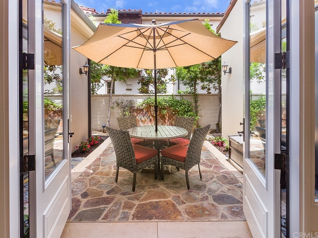 26 Tideline Bluff Newport Coast, CA 92657 - Photo 19 of 31 a view of a patio with a table chairs and a backyard