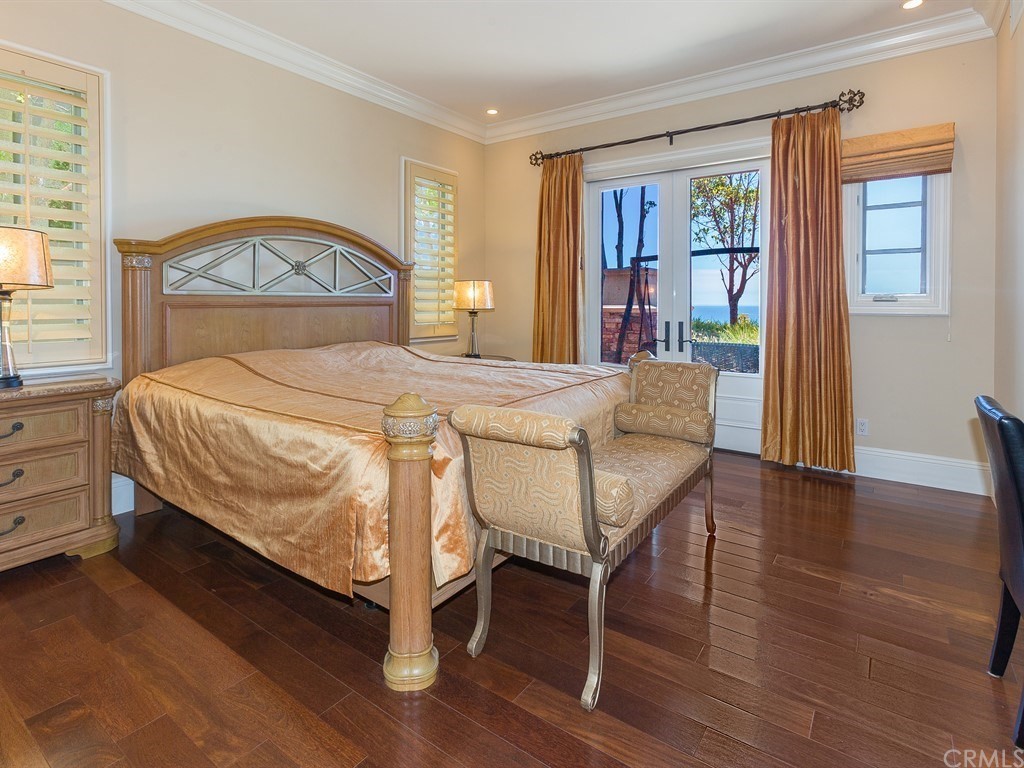 26 Tideline Bluff Newport Coast, CA 92657 - Photo 23 of 31 a bedroom with a bed a table and three windows