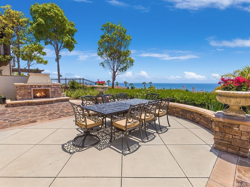 26 Tideline Bluff Newport Coast, CA 92657 - Photo 8 of 31 a view of a patio with table and chairs and potted plants