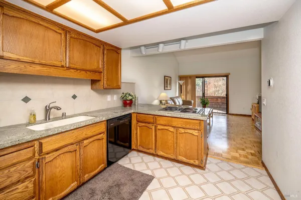 a kitchen with stainless steel appliances granite countertop a sink and cabinets