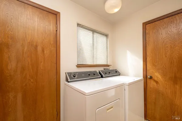 a view of an entryway with workspace and bedroom