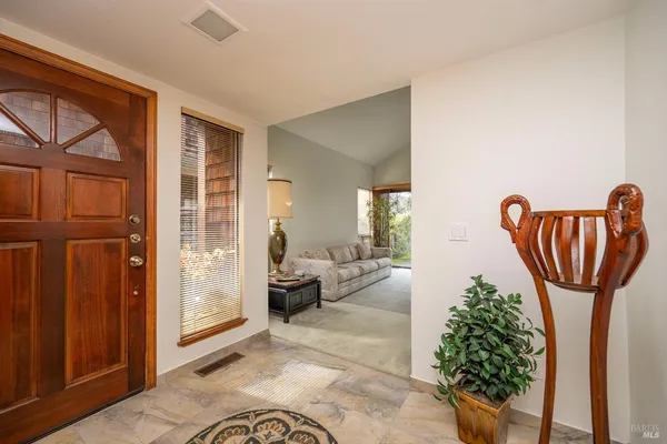 a view of hall way with furniture and entryway