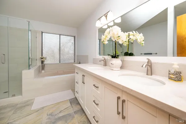a bathroom with a bathtub and shower