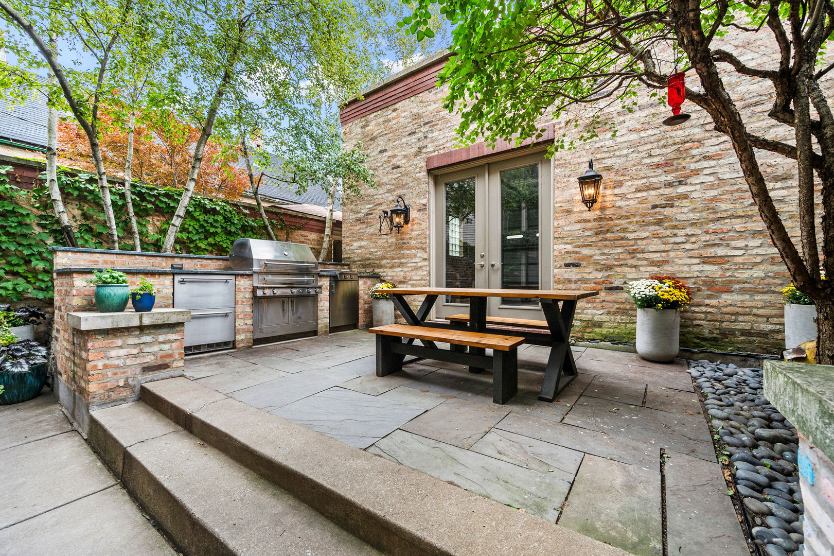 1421 West Lexington Street Chicago, IL 60607 - Photo 43 of 48 a backyard of a house with barbeque oven and outdoor seating