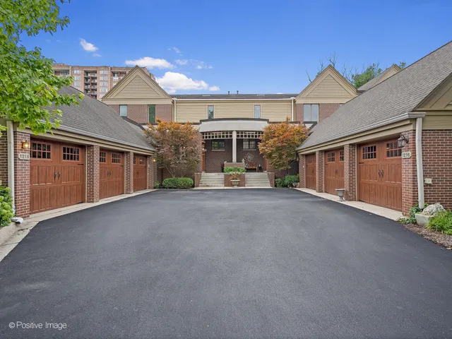 a view of a house with a garage and yard