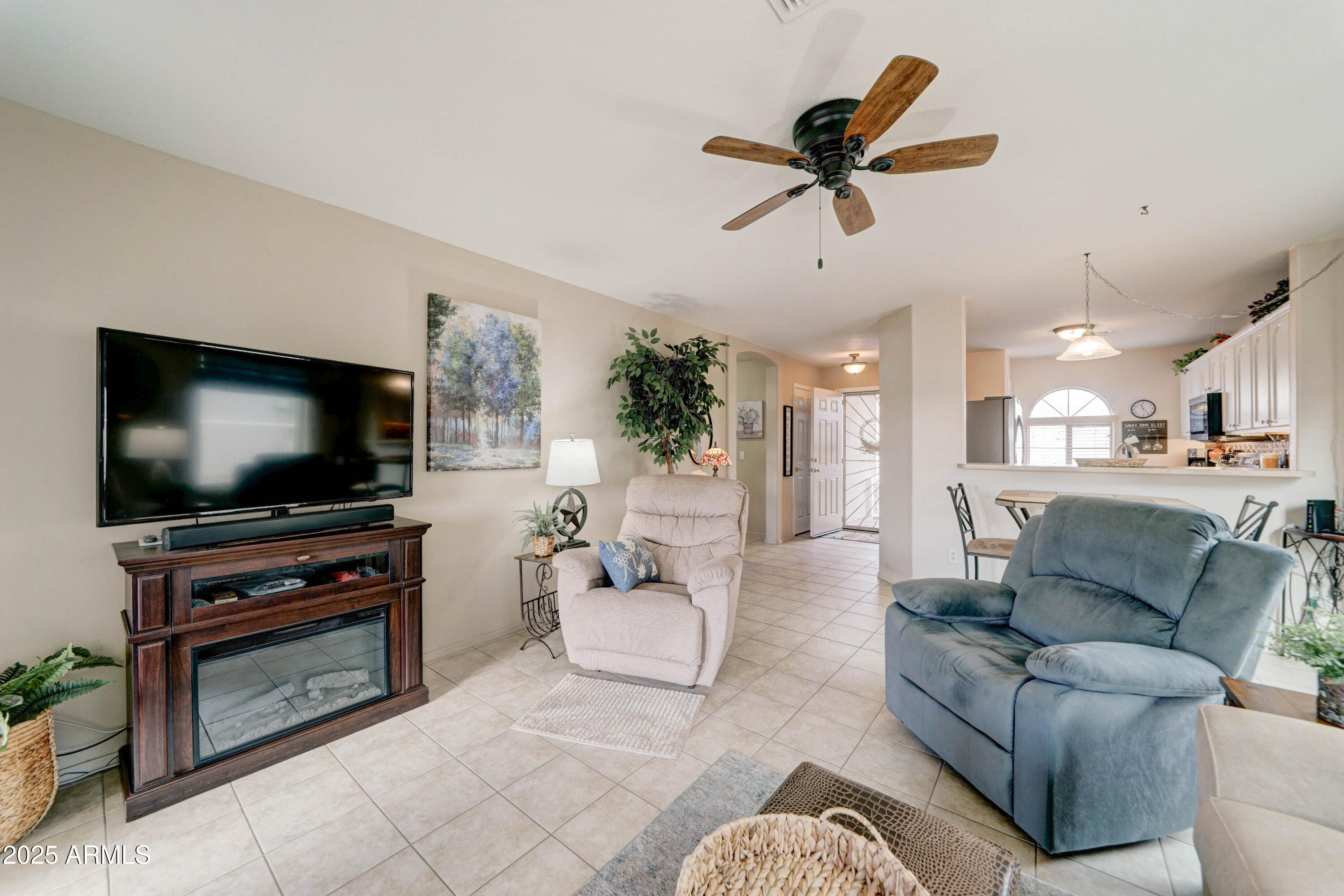 2101 South Meridian Road, Unit 432 Apache Junction, AZ 85120 - Photo 12 of 52 a living room with furniture and a flat screen tv with kitchen view
