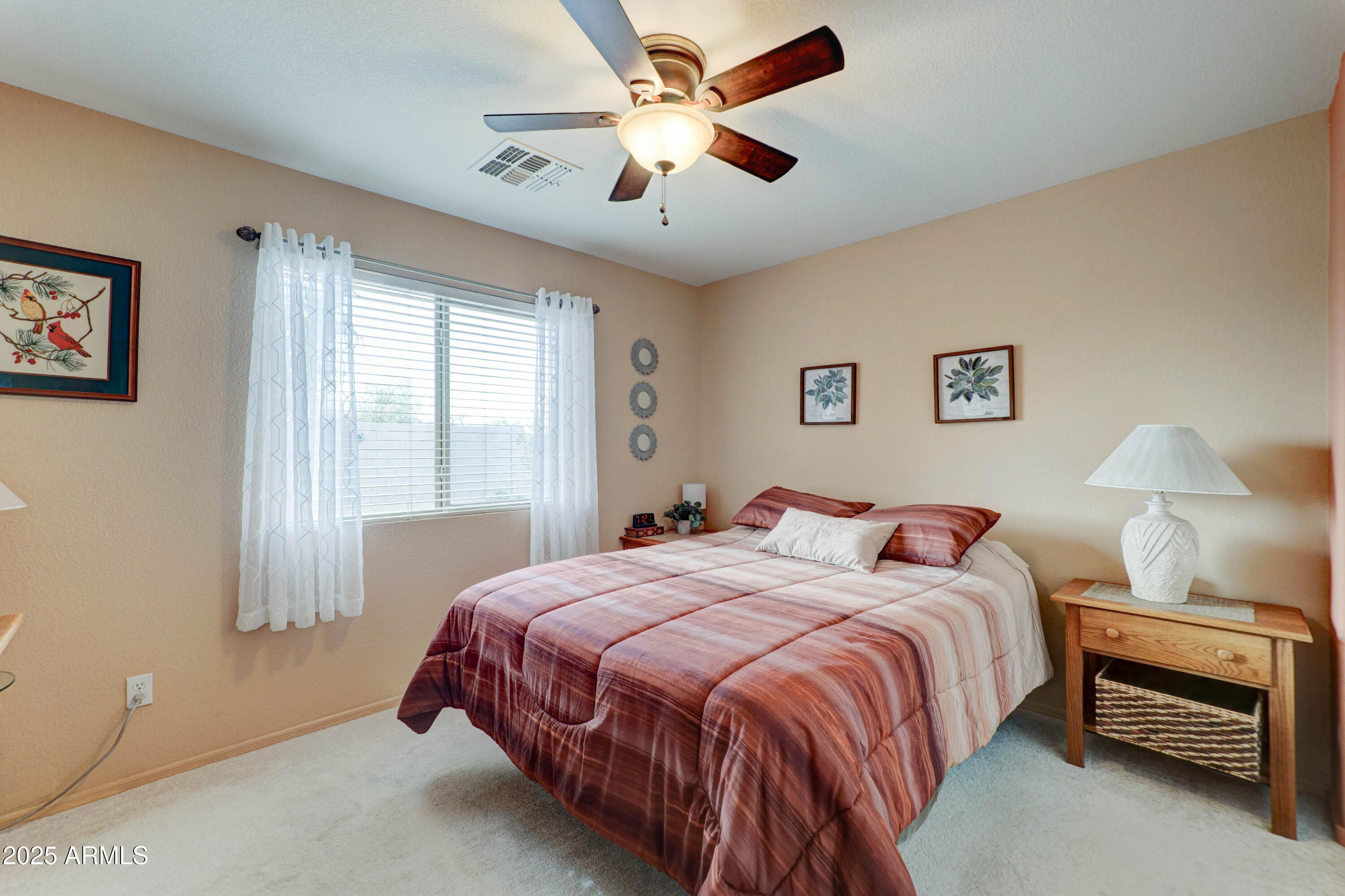2101 South Meridian Road, Unit 432 Apache Junction, AZ 85120 - Photo 13 of 52 a bedroom with a bed and a chandelier