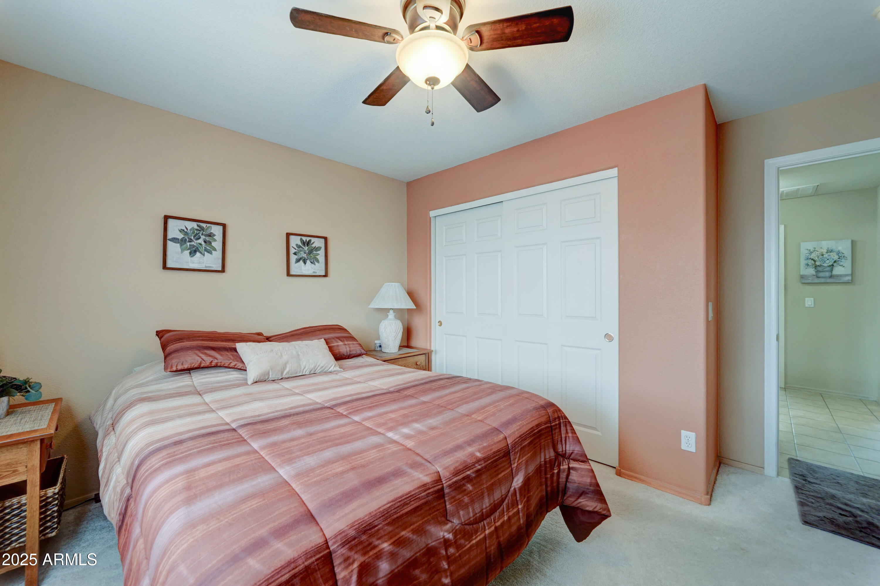 2101 South Meridian Road, Unit 432 Apache Junction, AZ 85120 - Photo 14 of 52 a bedroom with a bed and a chandelier