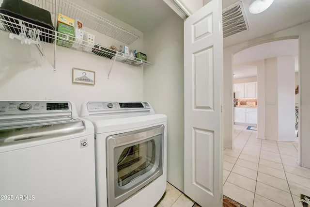 a view of washer and dryer with kitchen in the background