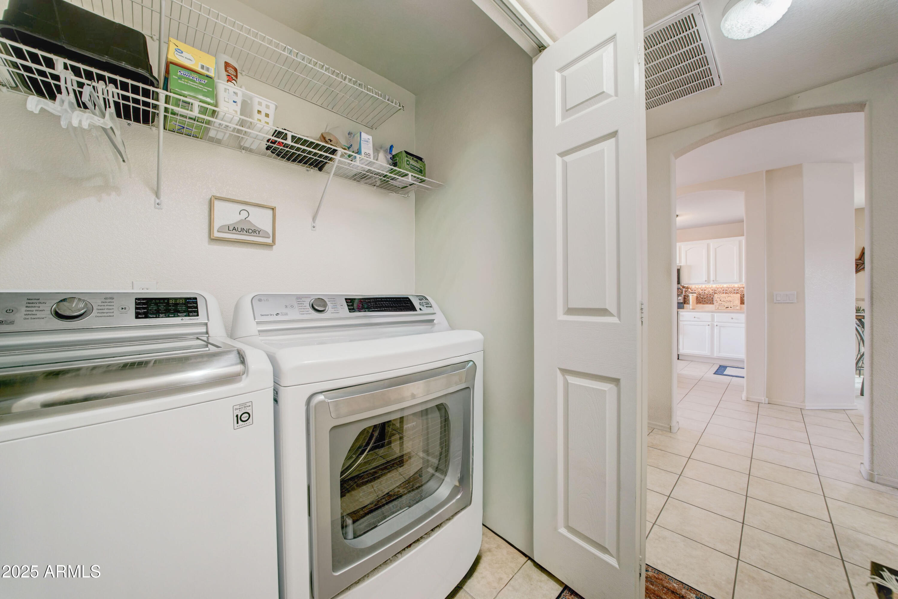 2101 South Meridian Road, Unit 432 Apache Junction, AZ 85120 - Photo 18 of 52 a view of washer and dryer with kitchen in the background