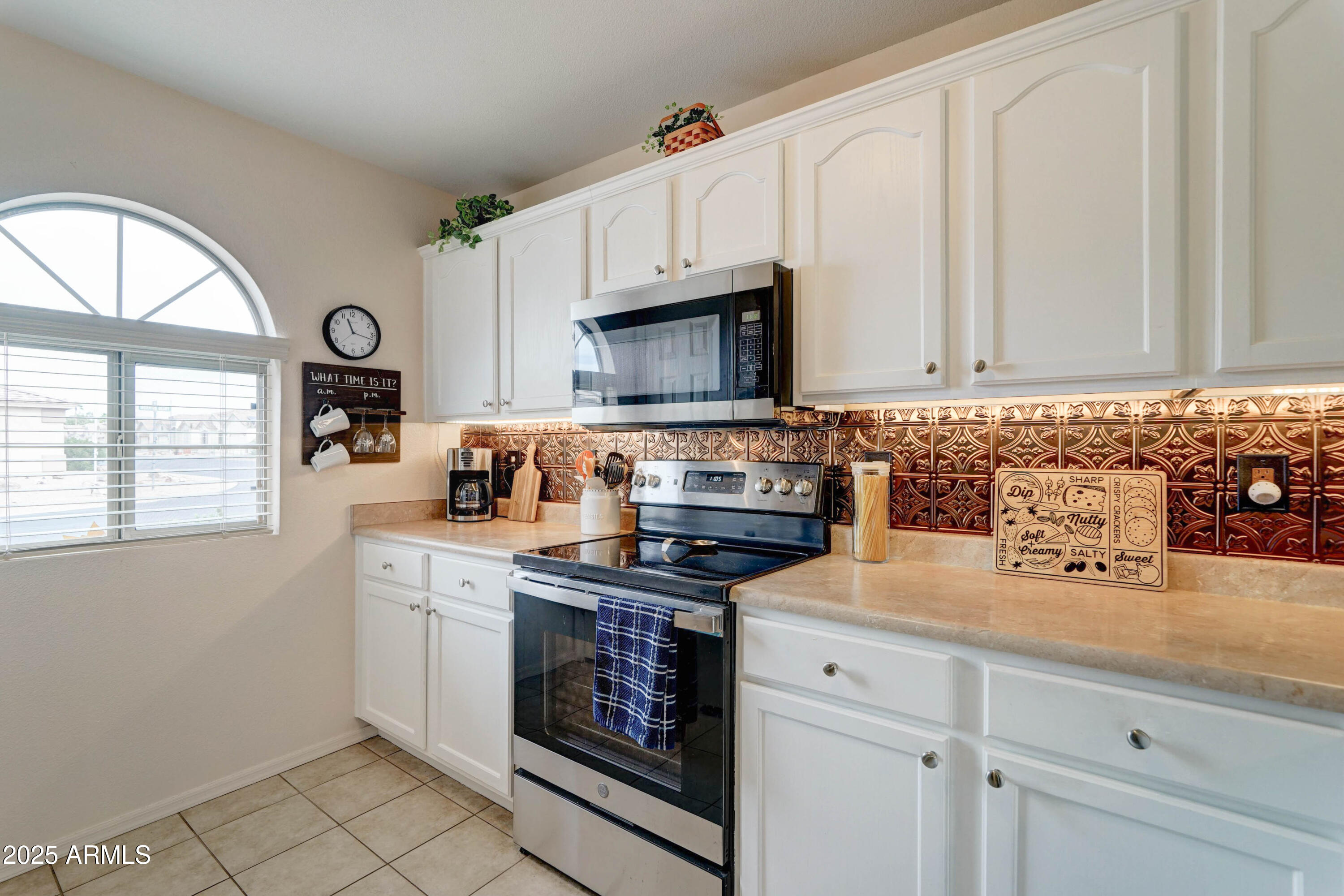 2101 South Meridian Road, Unit 432 Apache Junction, AZ 85120 - Photo 4 of 52 a kitchen with granite countertop a stove a sink and a microwave