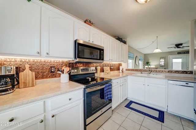 a kitchen with a sink stove and microwave
