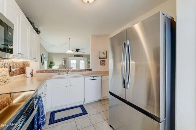 a kitchen with a sink stainless steel appliances and cabinets