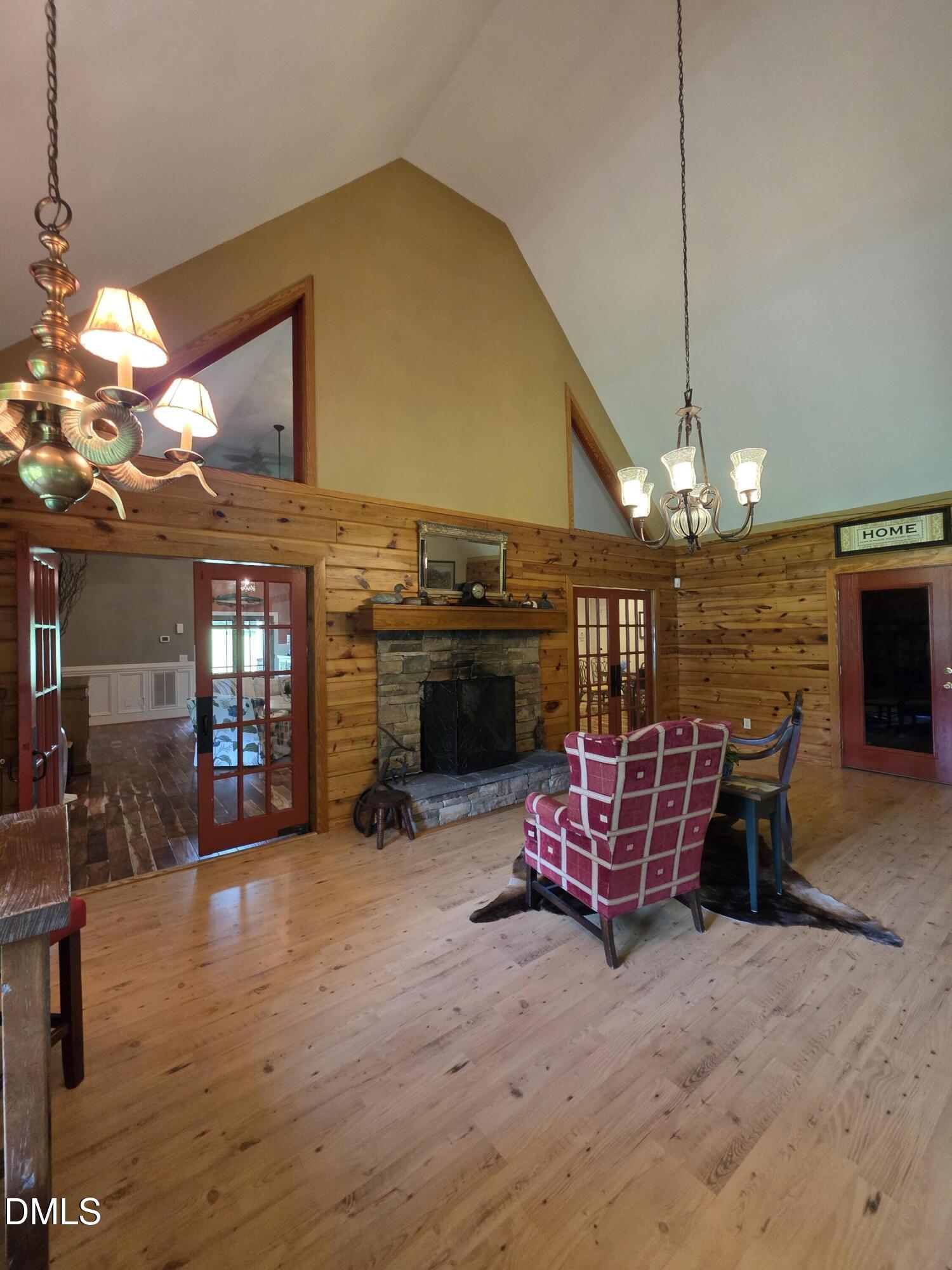 413 Johnson Town Road Zebulon, NC 27597 - Photo 22 of 42 a living room with furniture chandelier and a fireplace