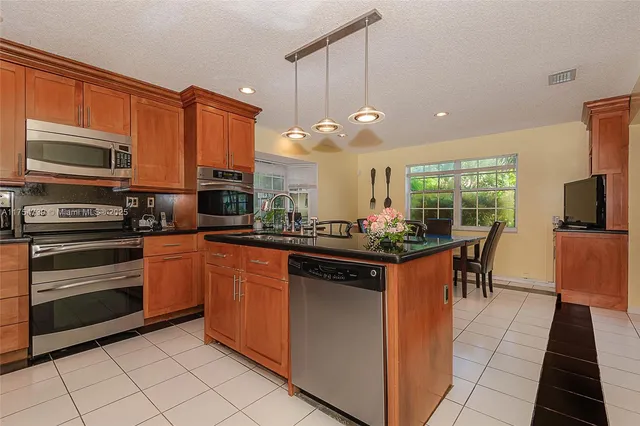a view of a dining room with furniture and a window