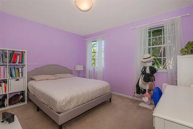 a bed room with a bed and a chair