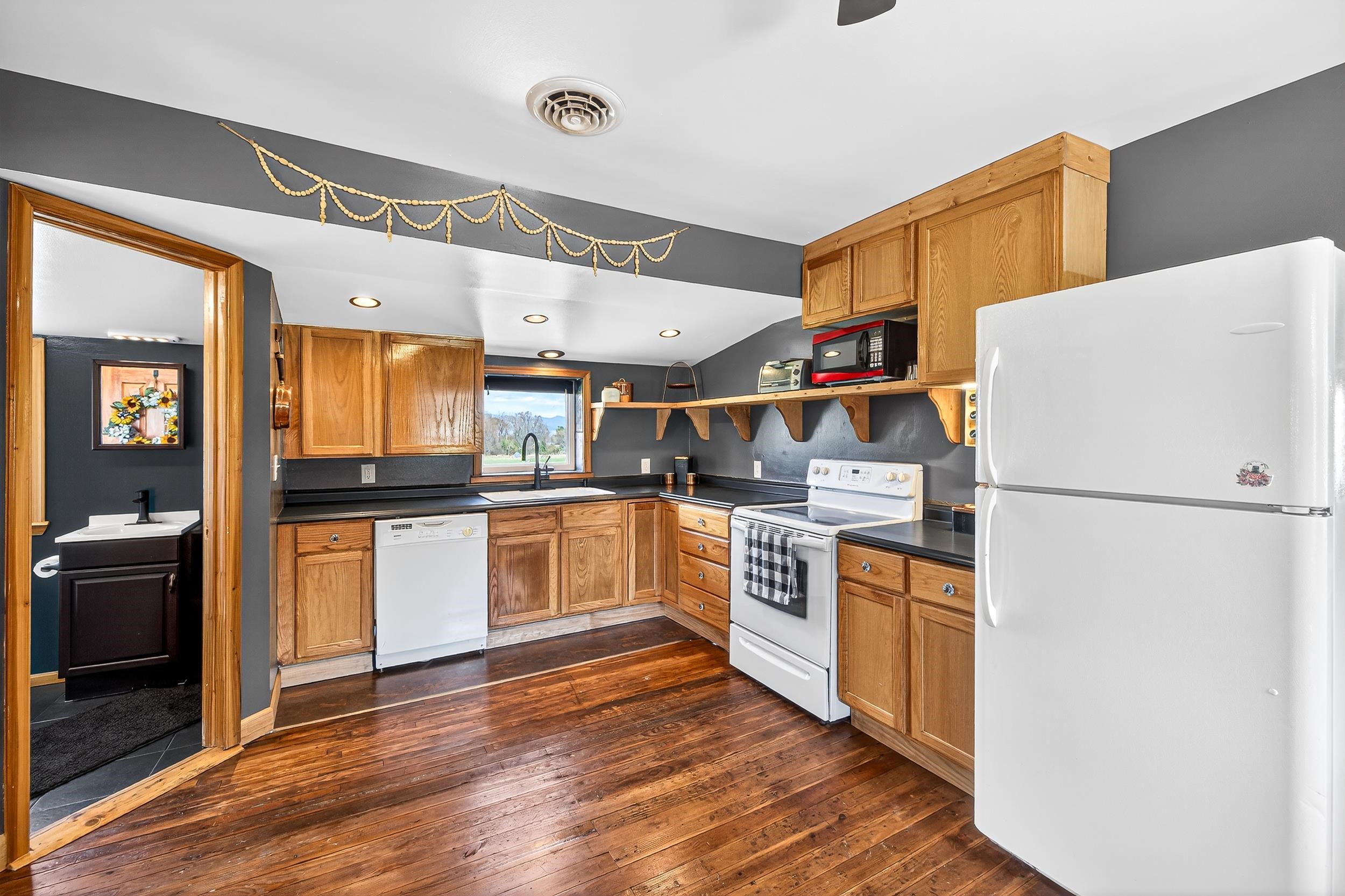 296 Keystone Road Stanley, VA 22851 - Photo 3 of 54 a kitchen with white cabinets and white appliances