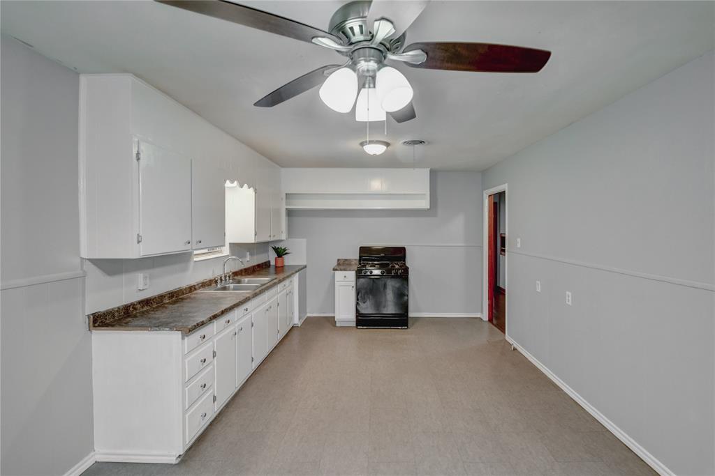 1002 North Stewart Street Azle, TX 76020 - Photo 19 of 29 a large white kitchen with a stove and a refrigerator