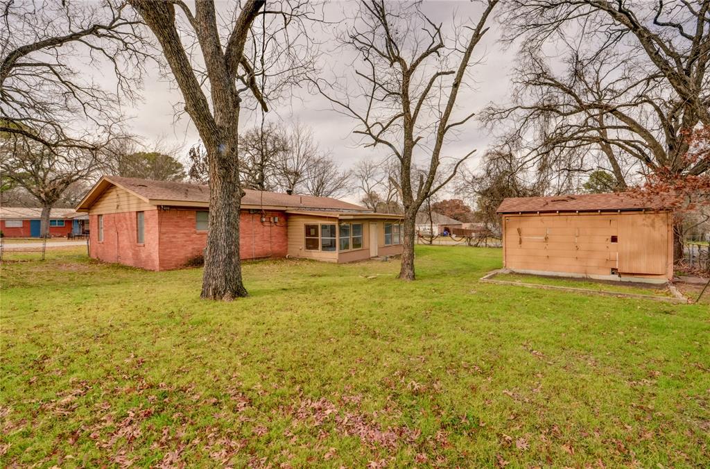 1002 North Stewart Street Azle, TX 76020 - Photo 28 of 29 a view of a yard with a house and a large tree