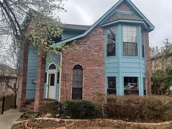 a front view of a house with plants