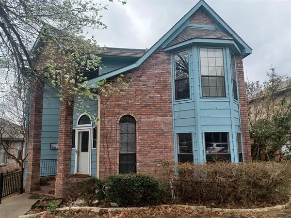 a front view of a house with plants