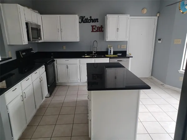 a kitchen with a sink a stove and refrigerator