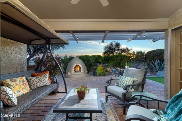 a backyard of a house with table and chairs