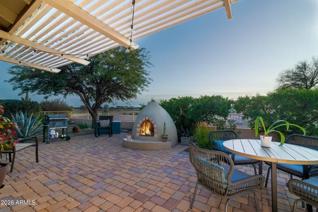a view of a dining room with furniture and a chandelier fan