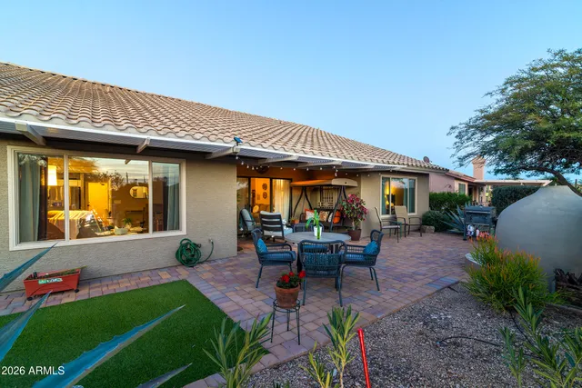 a view of a chairs and table in backyard