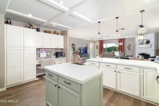 a kitchen with a sink a stove a refrigerator and white cabinets