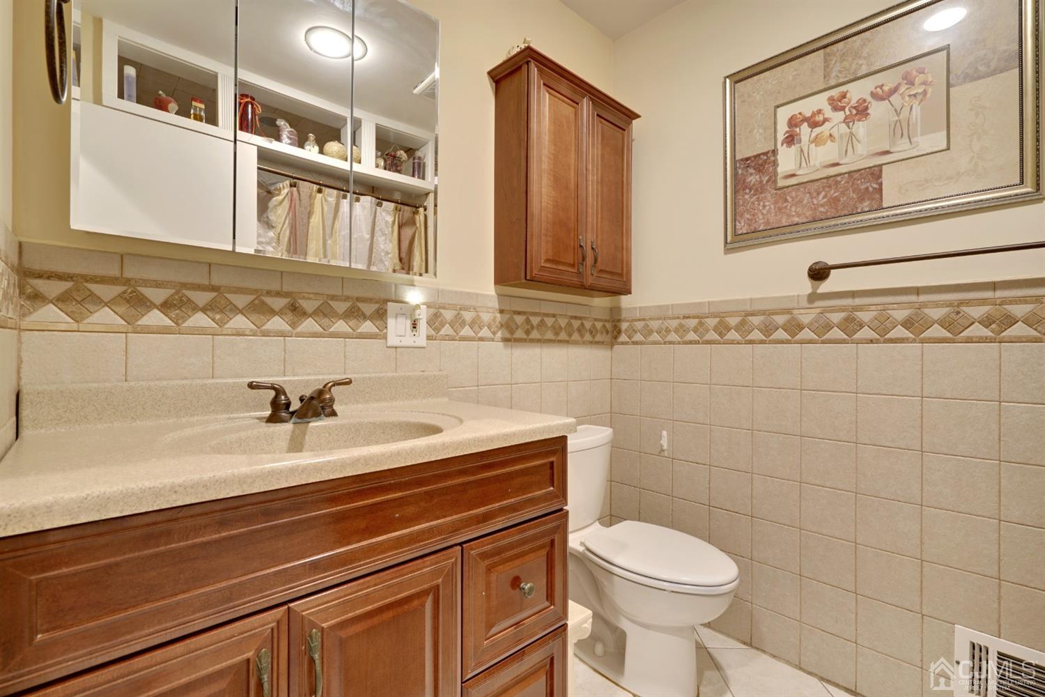 21 Palisade Road Linden, NJ 07036 - Photo 14 of 25 a bathroom with a sink a toilet and a mirror