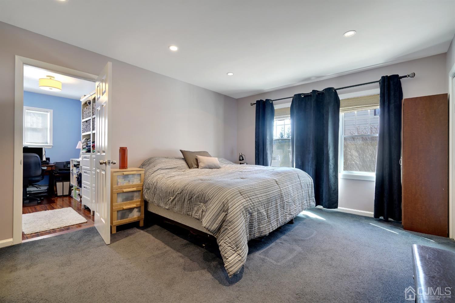 21 Palisade Road Linden, NJ 07036 - Photo 15 of 25 a spacious bedroom with a bed and a chandelier