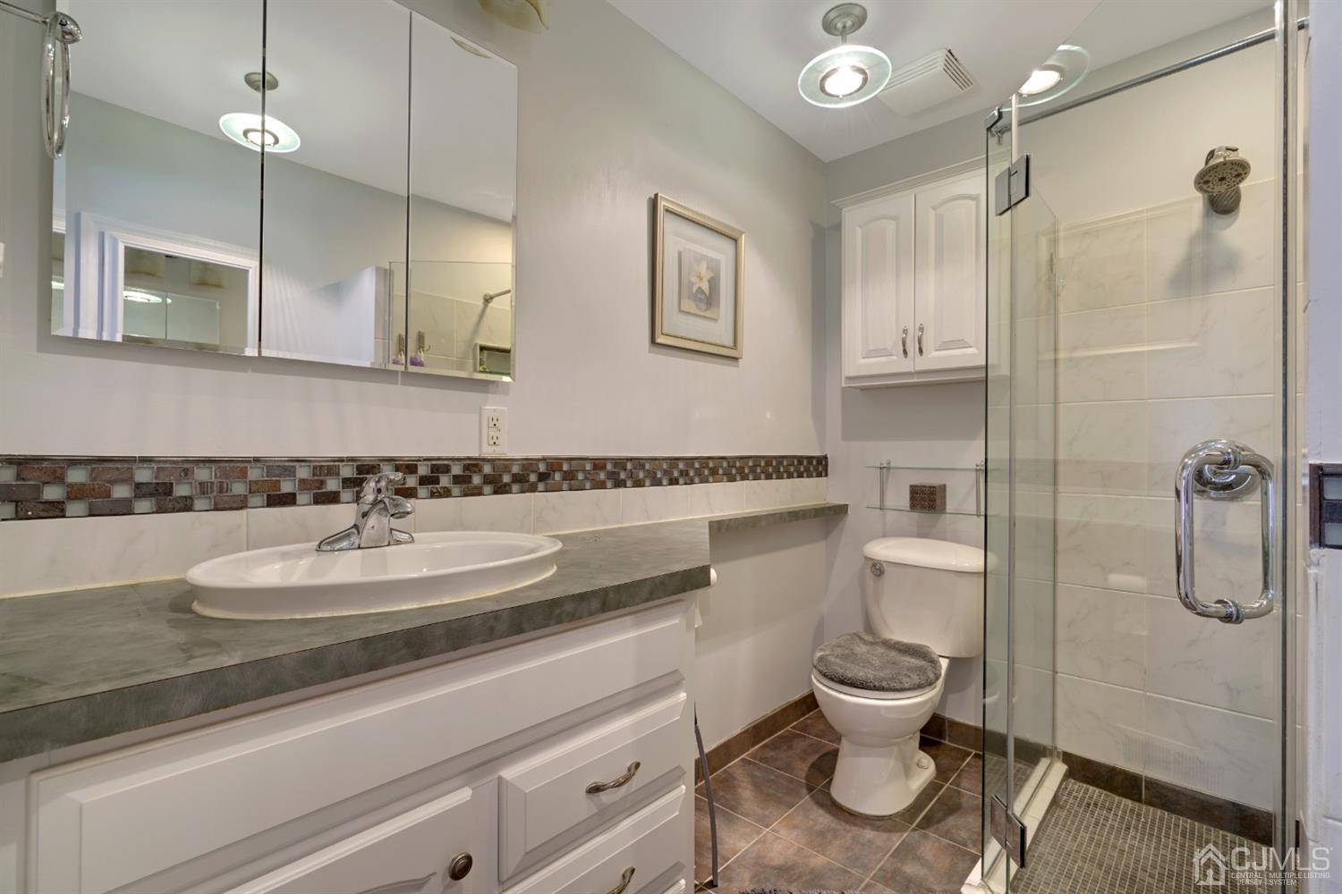 21 Palisade Road Linden, NJ 07036 - Photo 17 of 25 a bathroom with a granite countertop toilet sink and shower