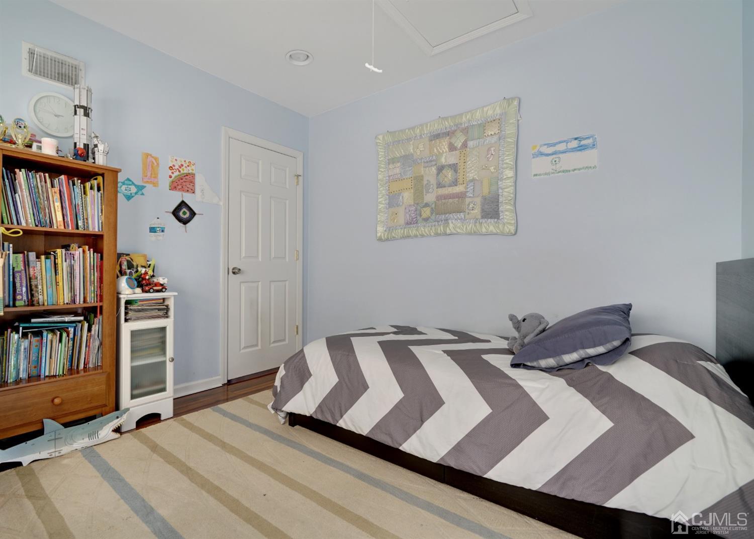 21 Palisade Road Linden, NJ 07036 - Photo 18 of 25 a bedroom with a bed and book shelf