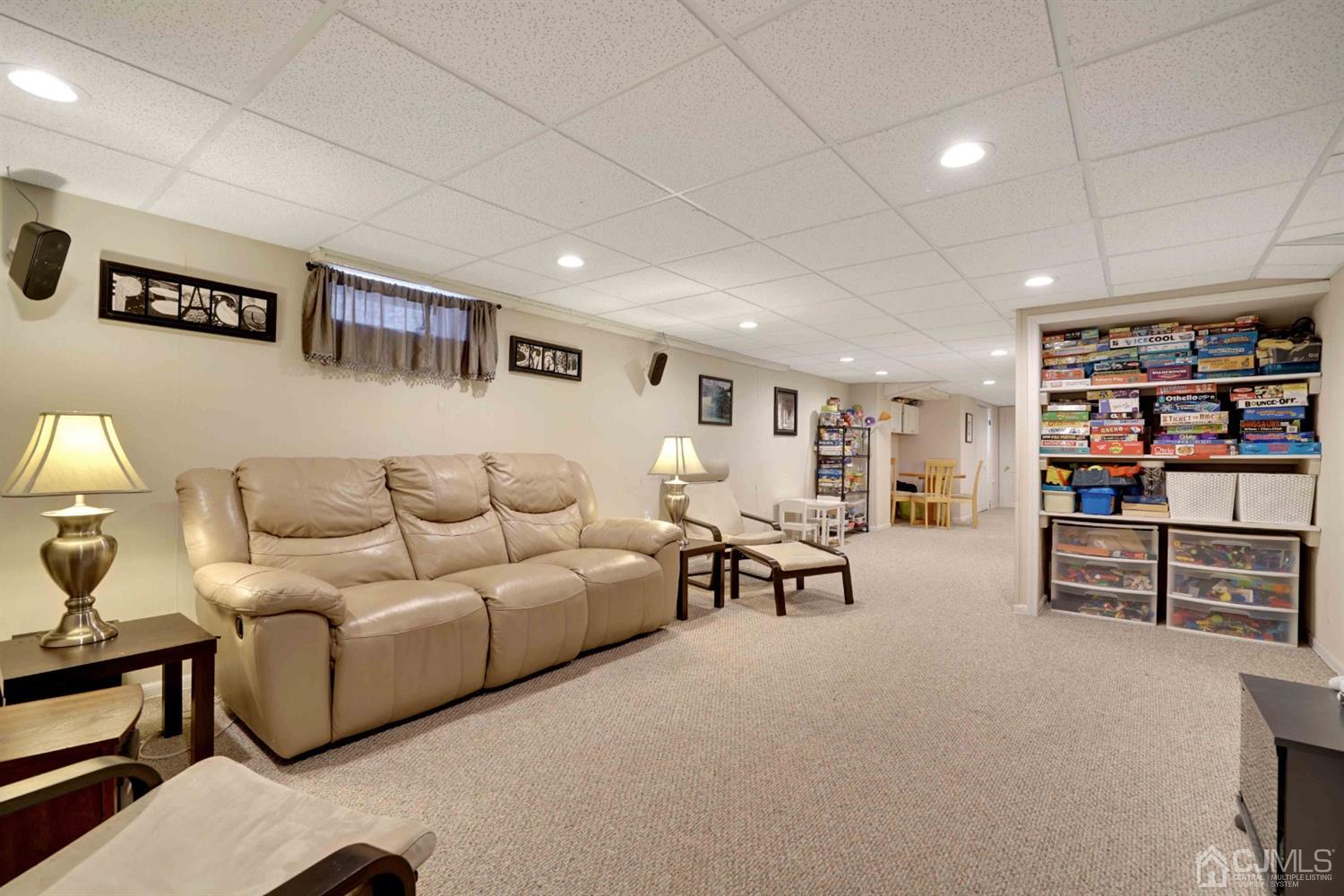21 Palisade Road Linden, NJ 07036 - Photo 20 of 25 a living room with furniture and a book shelf