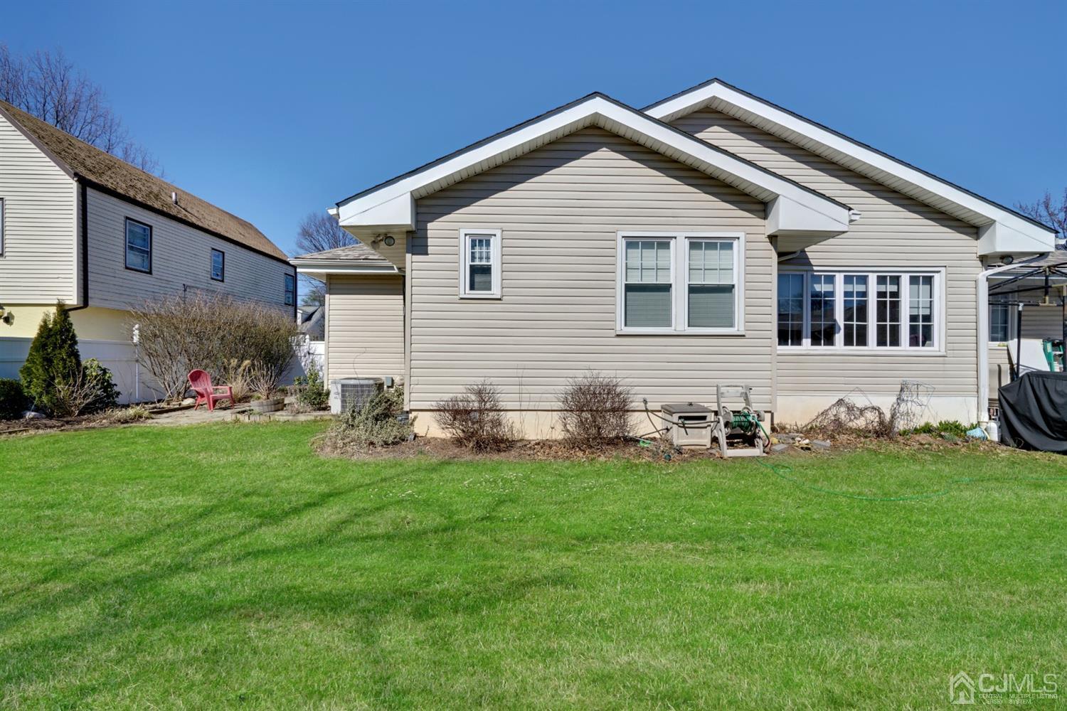 21 Palisade Road Linden, NJ 07036 - Photo 24 of 25 a front view of a house with a yard and garage
