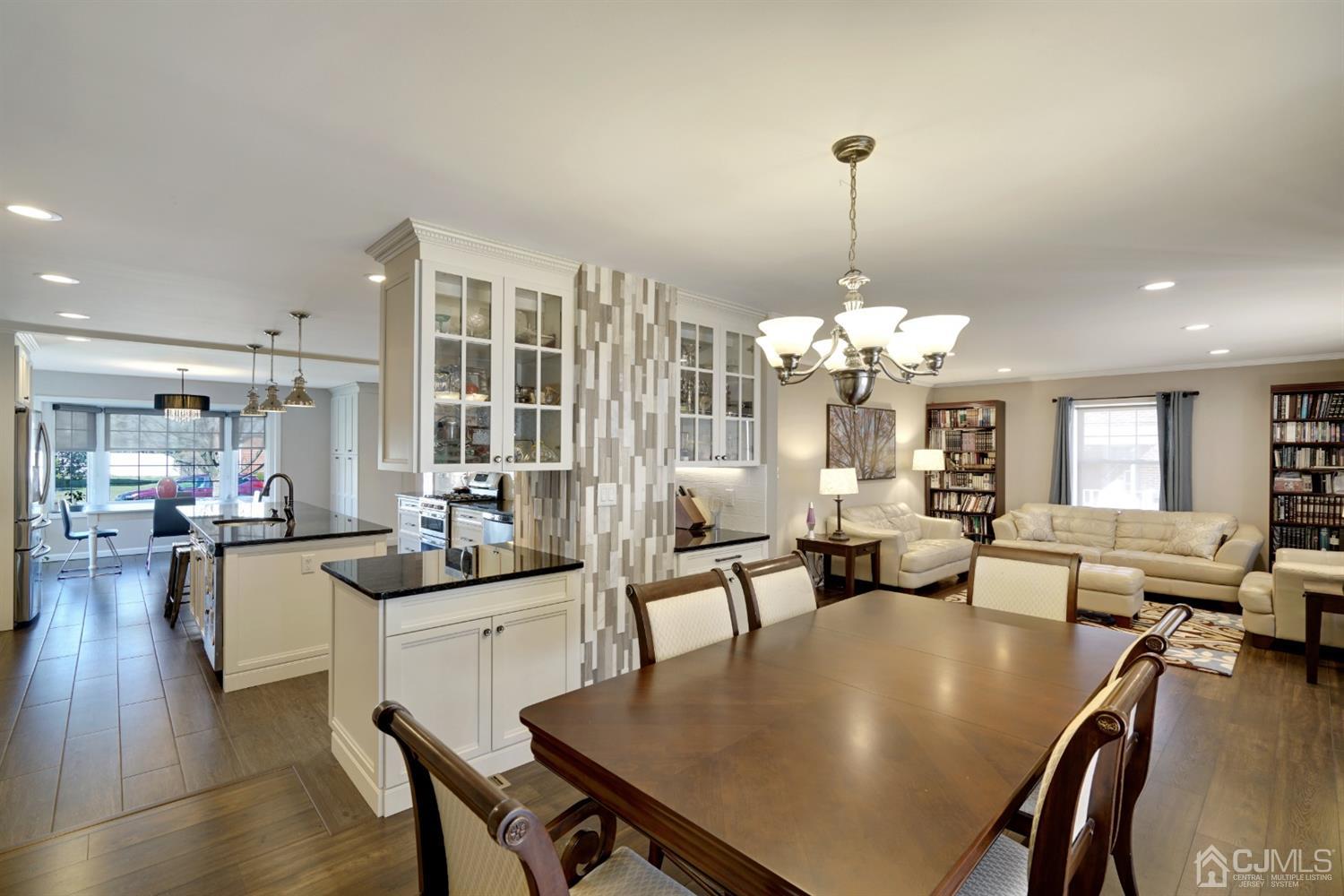 21 Palisade Road Linden, NJ 07036 - Photo 9 of 25 a view of a dining room and livingroom with furniture wooden floor a chandelier