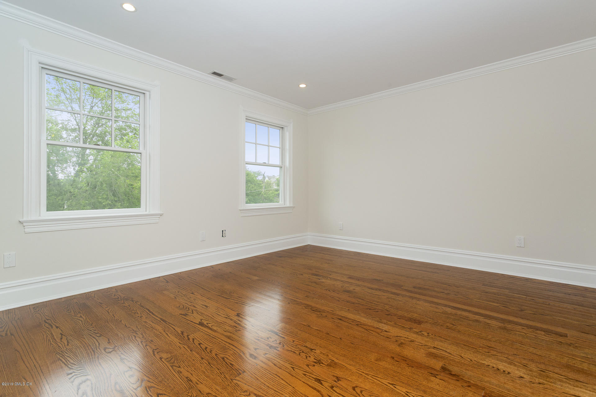 146 East Elm Street, Unit B Greenwich, CT 06830 - Photo 14 of 21 a view of an empty room with wooden floor and a window