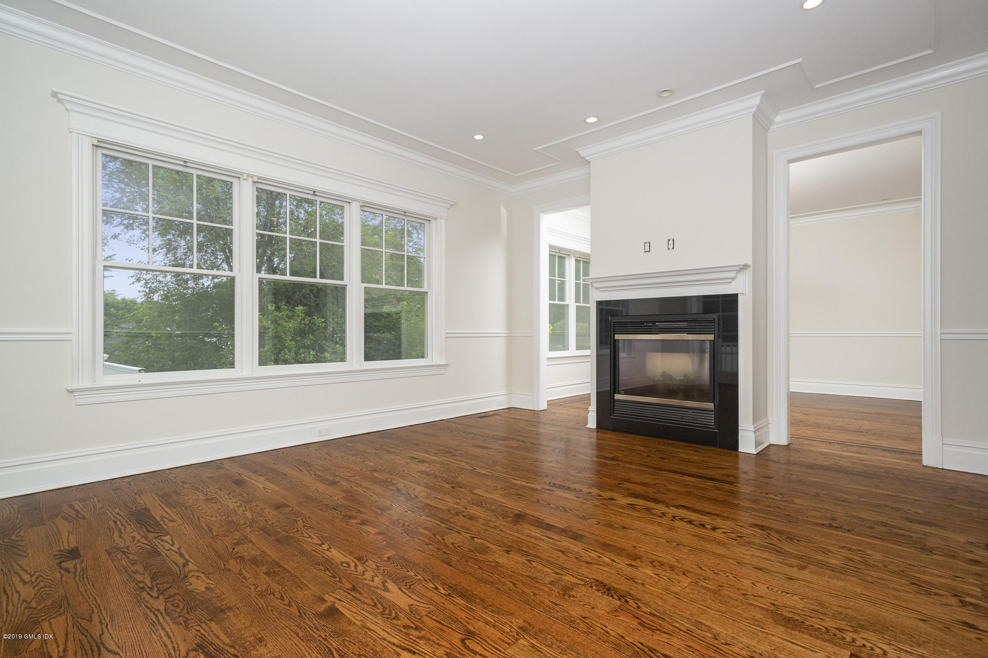 146 East Elm Street, Unit B Greenwich, CT 06830 - Photo 7 of 21 a view of an empty room with wooden floor and a window
