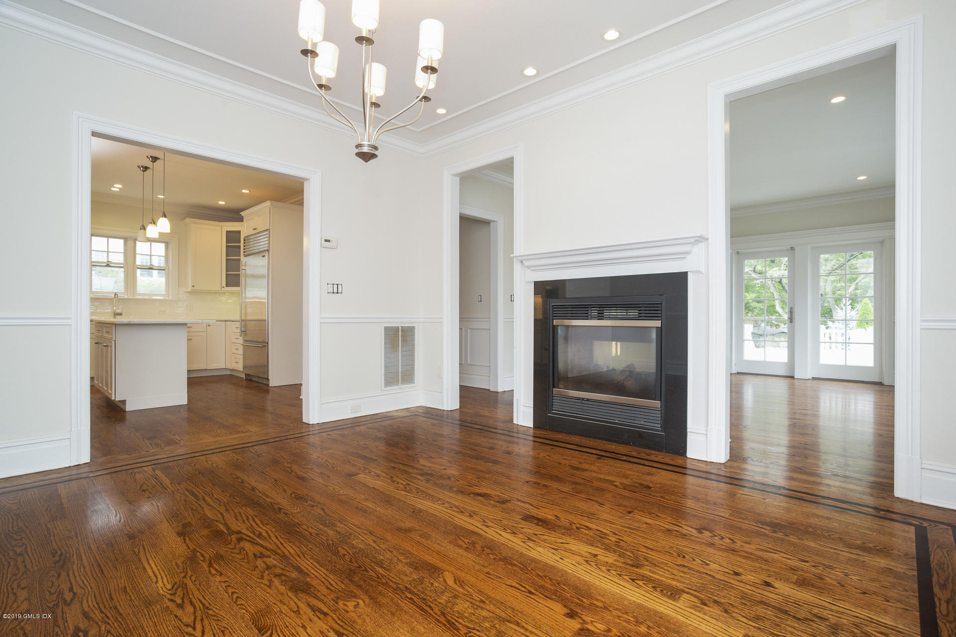 146 East Elm Street, Unit B Greenwich, CT 06830 - Photo 8 of 21 an empty room with wooden floor fireplace and windows