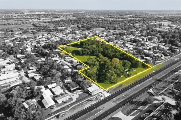 an aerial view of a residential houses with yard