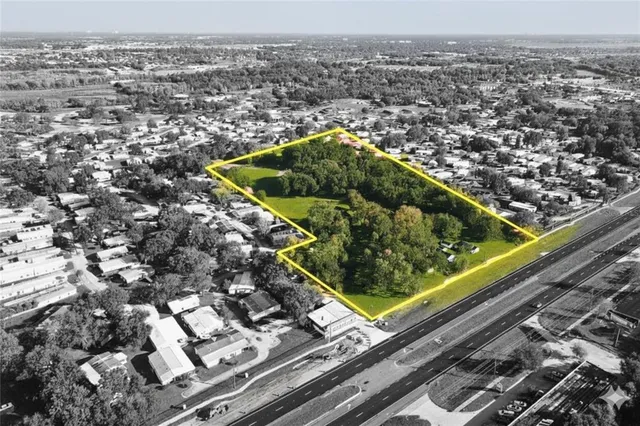 an aerial view of a residential houses with yard
