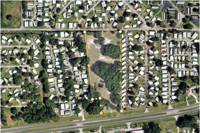 an aerial view of residential houses with city view