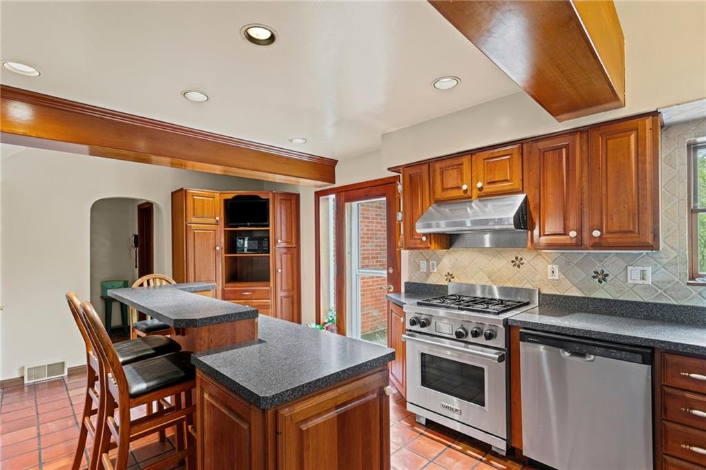 1445 Dutch Ridge Road Beaver, PA 15009 - Photo 12 of 43 a kitchen with stainless steel appliances granite countertop a stove a sink dishwasher and a refrigerator