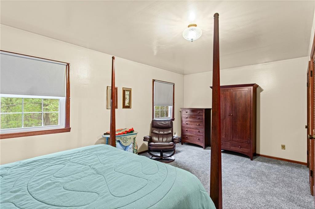 1445 Dutch Ridge Road Beaver, PA 15009 - Photo 25 of 43 a bedroom with a bed and a large mirror